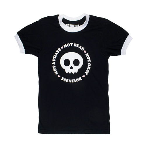Black shirt with white trim around sleeves and collar. A skull sits in the middle with the phrase 